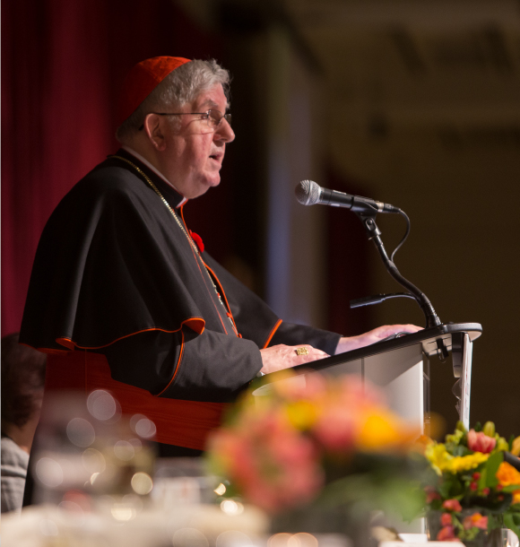 Cardinal Thomas Collins speaks at a podium