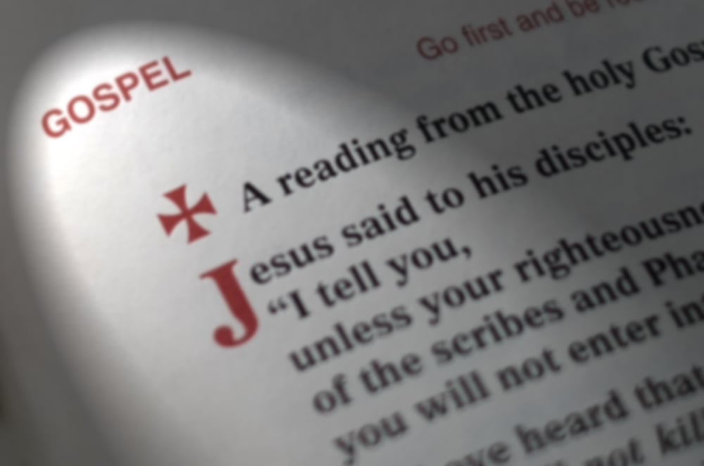 Gospel text blurred